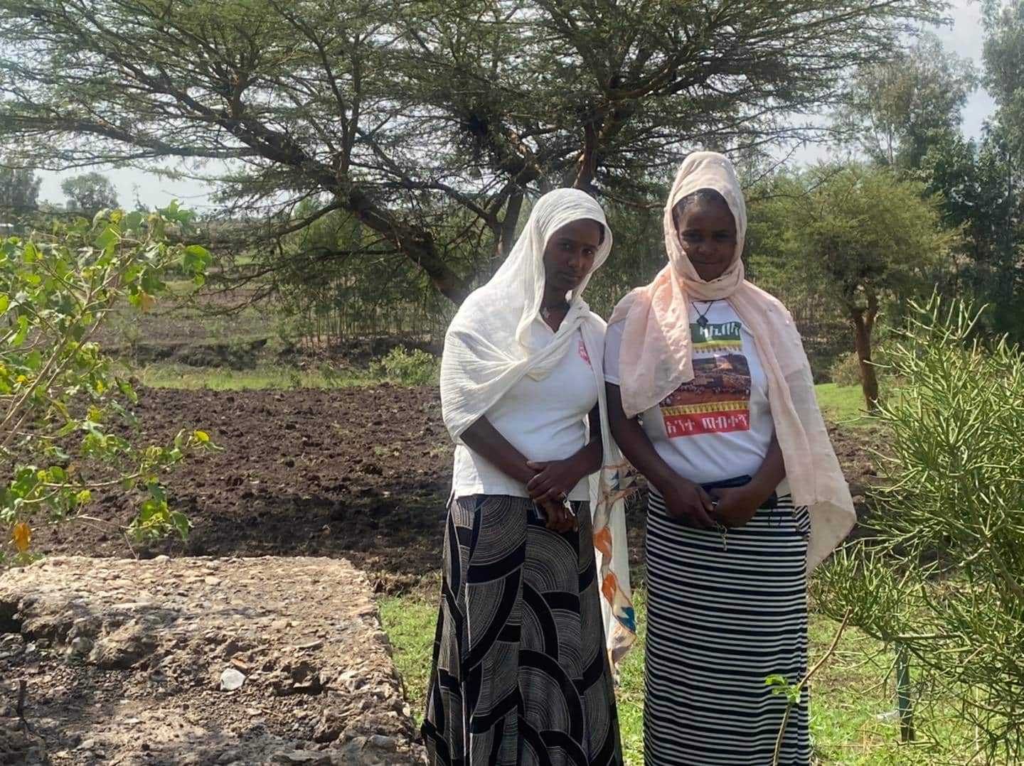 Women contractors gather at the site where we will in install our 100th water source