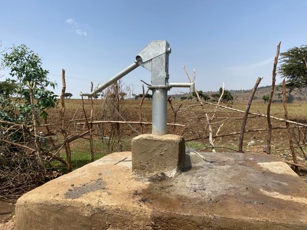 A handpump sits on top of a hand-dug well in Denkaz