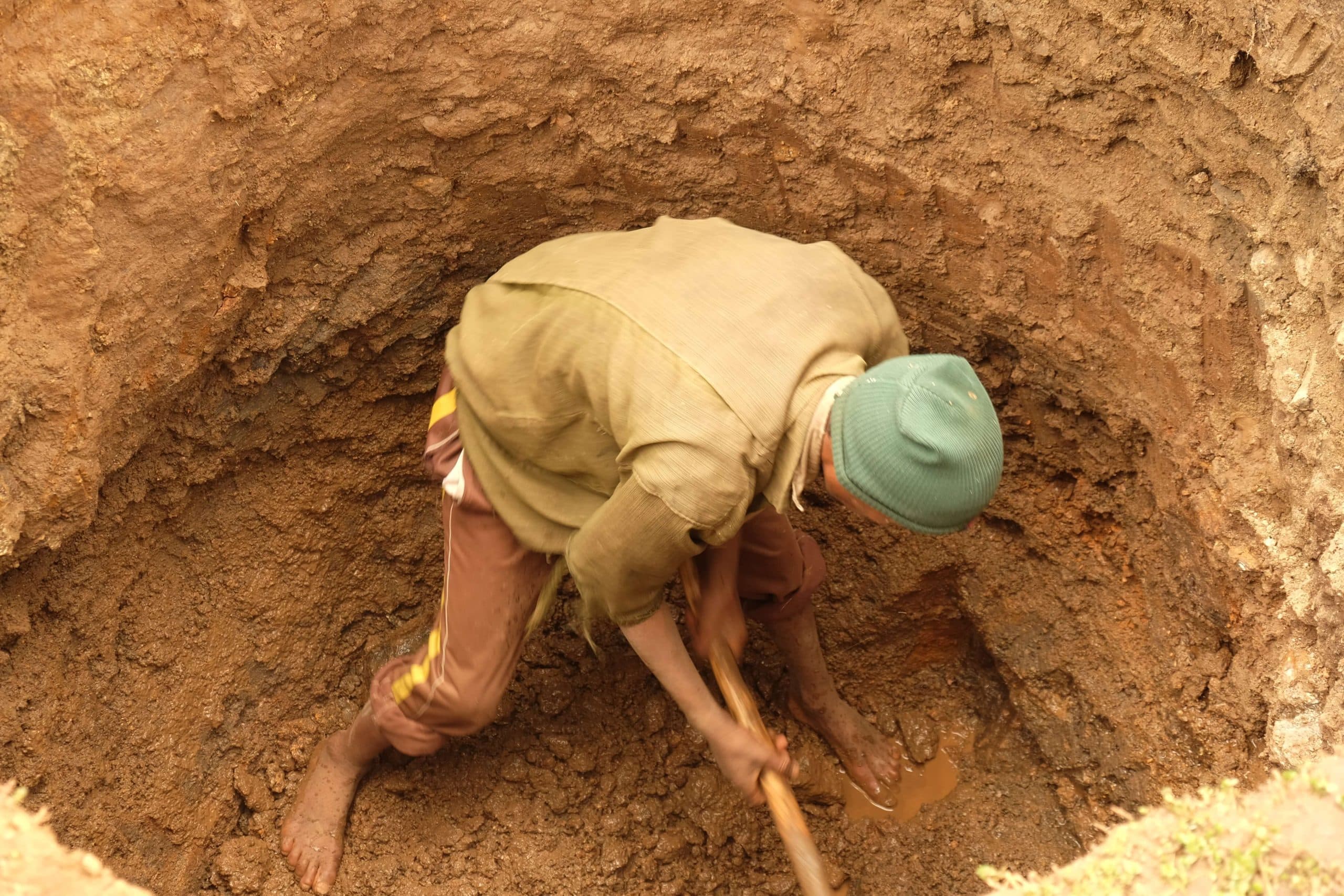 Man digging deep well