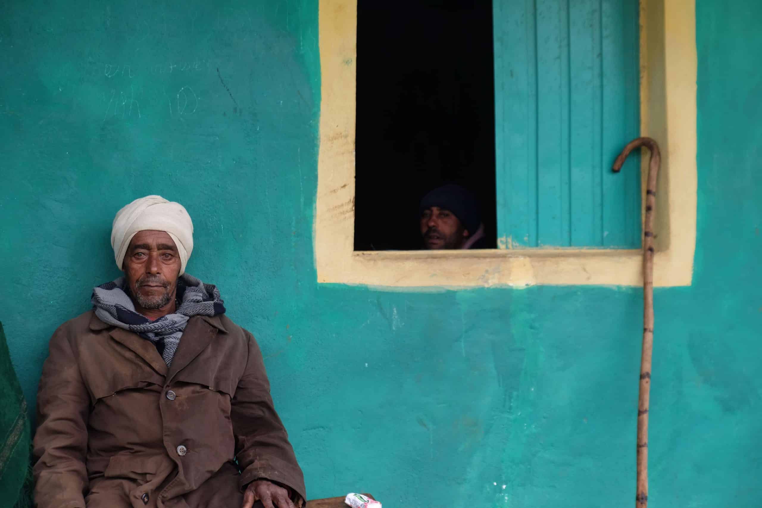 Man outside colourful building